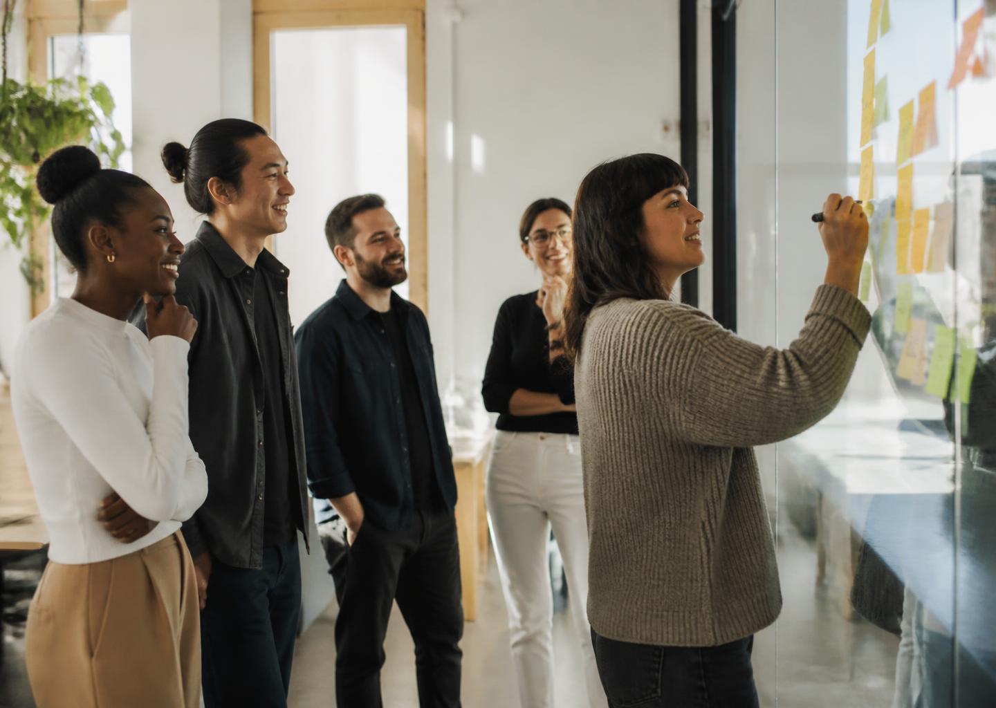 A presenter leading a working session with senior executives in a boardroom